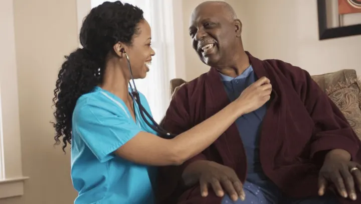 nurse checking heart beat of elderly man